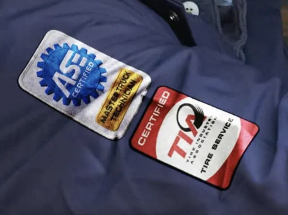 ASE Certified and TIA Certified patches on a technician uniform